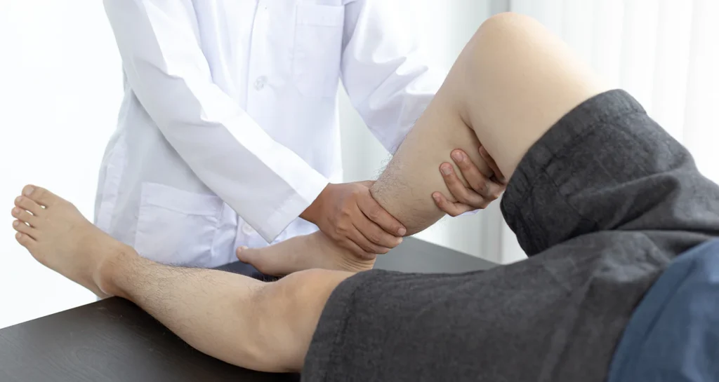 adult receiving leg exam from medical